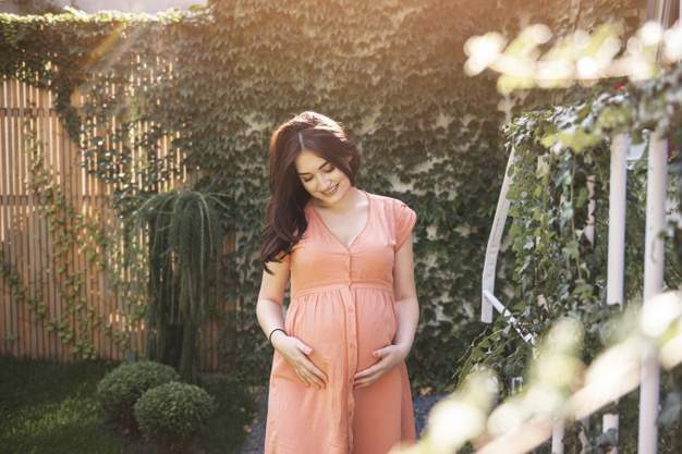 beautiful pregnant woman with floral wreath outdoors 23 2148366272