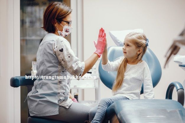 cute little girl sitting dentist s office 1157 19466 1